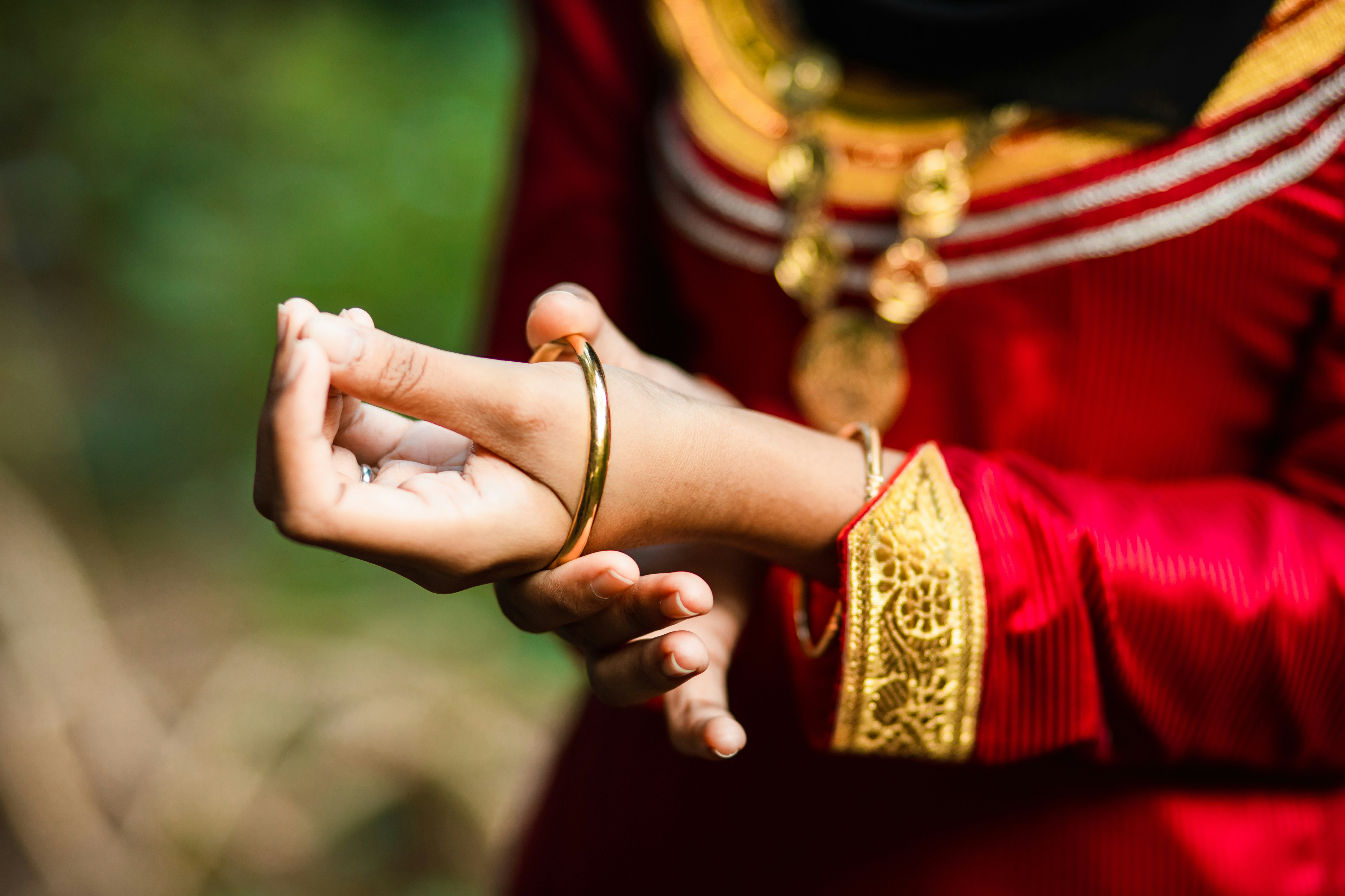 person wearing gold ring and bracelet